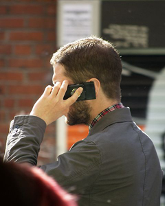 Man speaking on mobile phone: A mobile phone can contain 500 to 1,000 components. Many of these contain toxic heavy metals such as lead, mercury, cadmium and beryllium, and hazardous chemicals, such as brominated flame retardants (BFR). Photograph courtesy of Wikipedia.